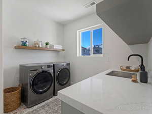 Laundry area featuring independent washer and dryer