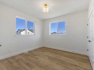 Spare room with light wood finished floors and baseboards