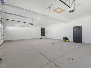 Garage featuring recessed lighting and a garage door opener