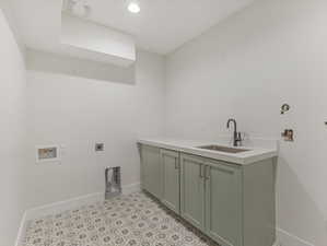 Laundry area with electric dryer hookup, washer hookup, cabinet space, and recessed lighting