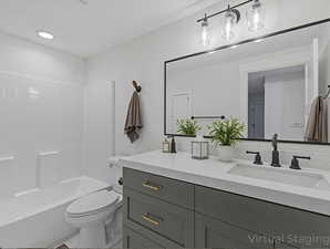 Bathroom with vanity, shower / bathtub combination, and light tile patterned flooring