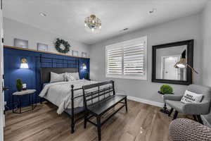 Bedroom with wood finished floors and recessed lighting