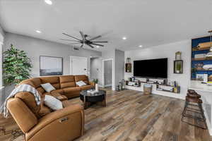 Living area with wood finished floors, a ceiling fan, and recessed lighting