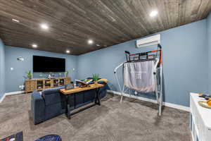 Carpeted living area with wood ceiling and recessed lighting