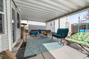 Sunroom / solarium featuring a patio area and an outdoor hangout area