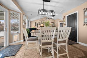Dining space with lofted ceiling, a ceiling fan, recessed lighting, and light wood-style flooring
