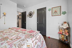 Bedroom featuring baseboards and dark wood finished floors