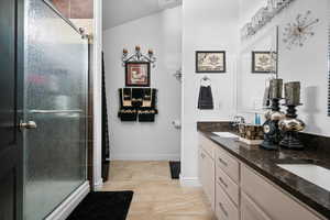 Bathroom with a shower stall and double vanity