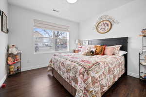 Bedroom featuring baseboards and dark wood-style floors