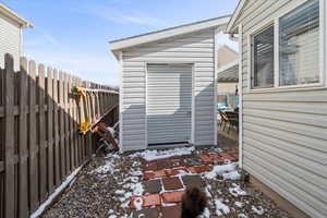View of shed with a fenced backyard
