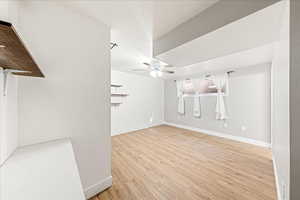 Unfurnished living room featuring light wood-type flooring and a ceiling fan