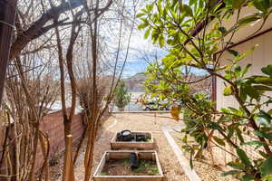 Fenced backyard featuring a garden and a patio