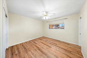 Unfurnished bedroom with light wood-style floors, a closet, and ceiling fan