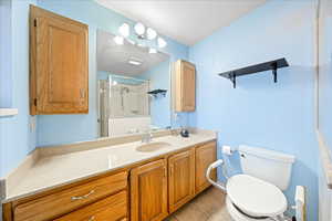 Full bath with vanity, a stall shower, and light tile patterned floors