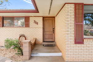 View of exterior entry with brick siding