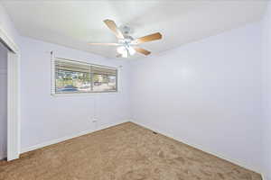 Unfurnished bedroom with a closet, carpet, and ceiling fan