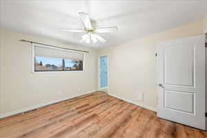 Unfurnished bedroom with light wood finished floors and ceiling fan