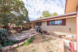 Rear view of house with a patio and brick siding