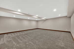 Finished basement featuring carpet floors and recessed lighting