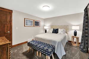 Bedroom featuring carpet floors and baseboards