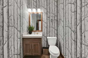 Bathroom featuring vanity and wallpapered walls