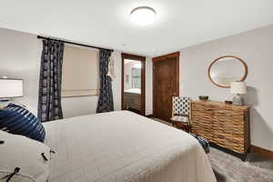 Bedroom featuring carpet flooring and connected bathroom