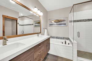 Full bath featuring double vanity, a bath, and a stall shower