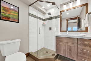 Full bath featuring vanity and a stall shower