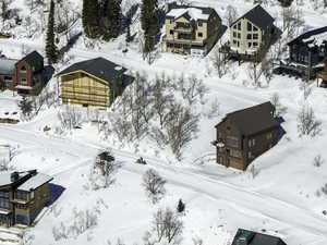 Snowy aerial view featuring a residential view