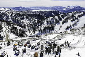 Snowy aerial view featuring a mountain view