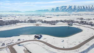 Snowy aerial view with a water and mountain view