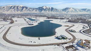 Snowy aerial view featuring a water and mountain view