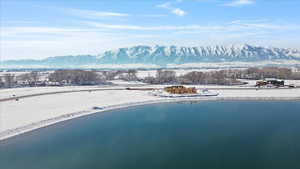 Snowy aerial view with a water and mountain view