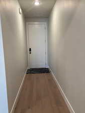Hall with baseboards and light wood-type flooring