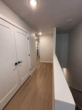 Hallway with light wood finished floors and baseboards