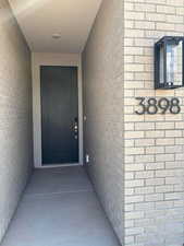 Property entrance featuring brick siding