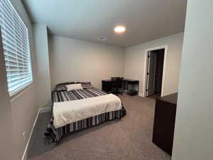 Bedroom featuring an office area and carpet