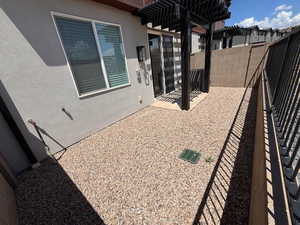 Fenced backyard featuring a patio area and a pergola