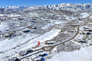 Snowy aerial view featuring a mountain view