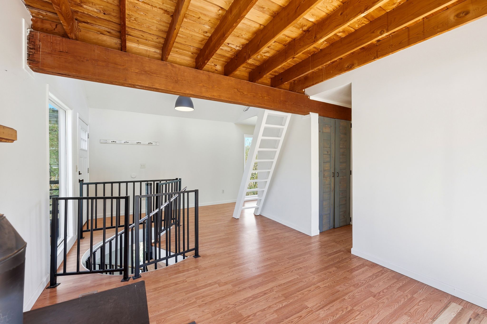 Exposed wood beam ceiling with natural wood finish flooring