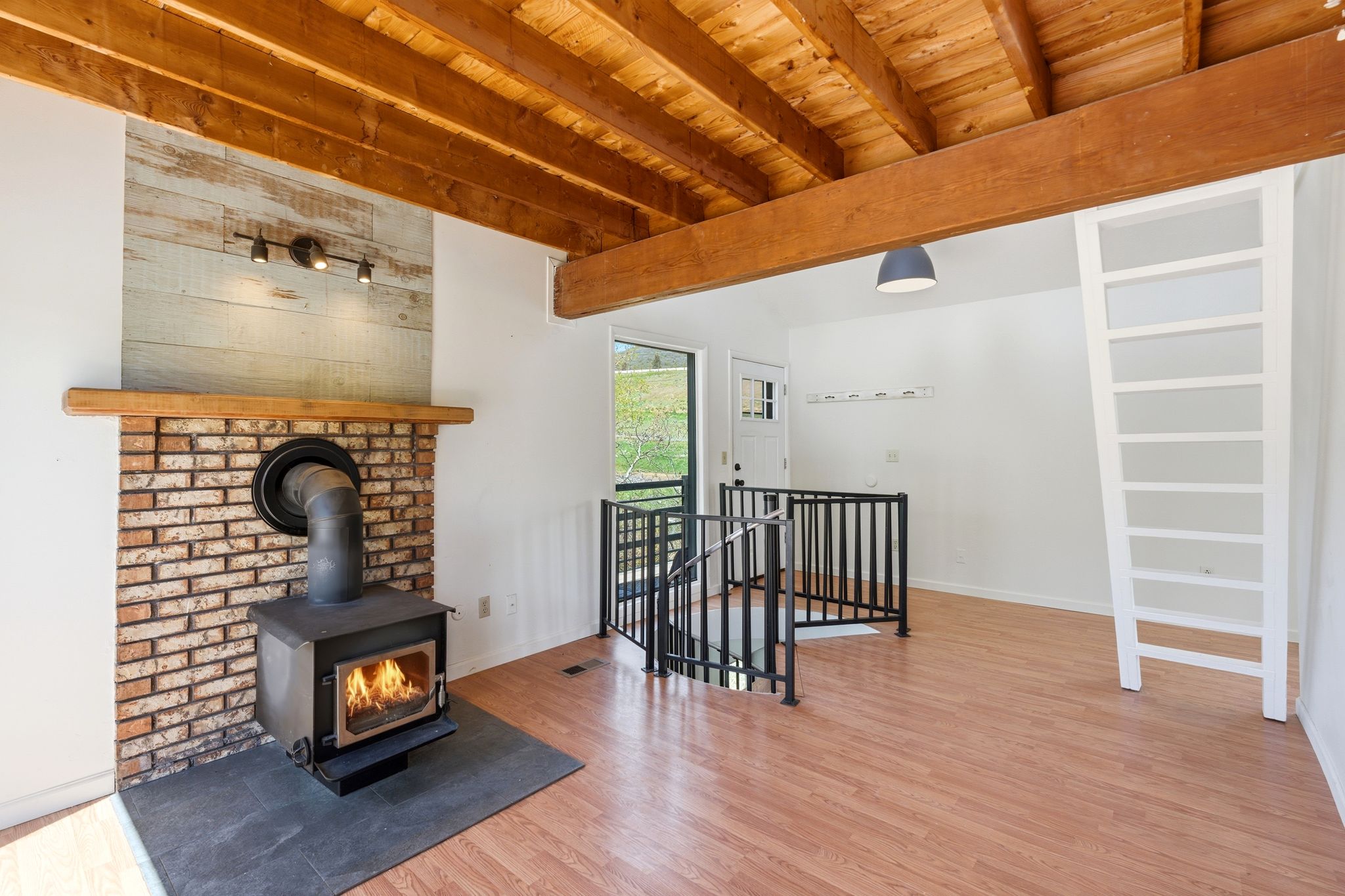 Exposed wood beam ceiling with wood-finish flooring