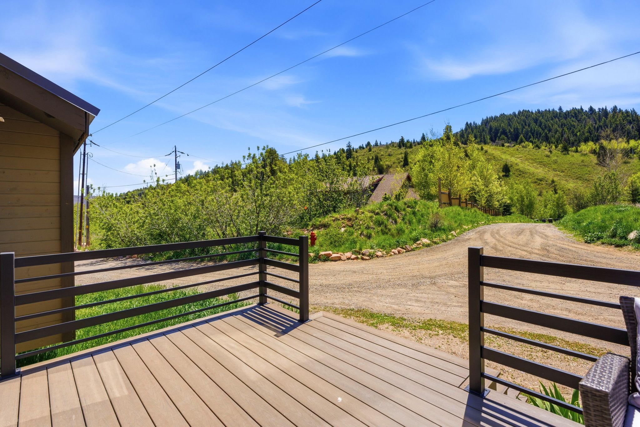 Outdoor deck featuring wood-finish composite decking and a dark metal railing