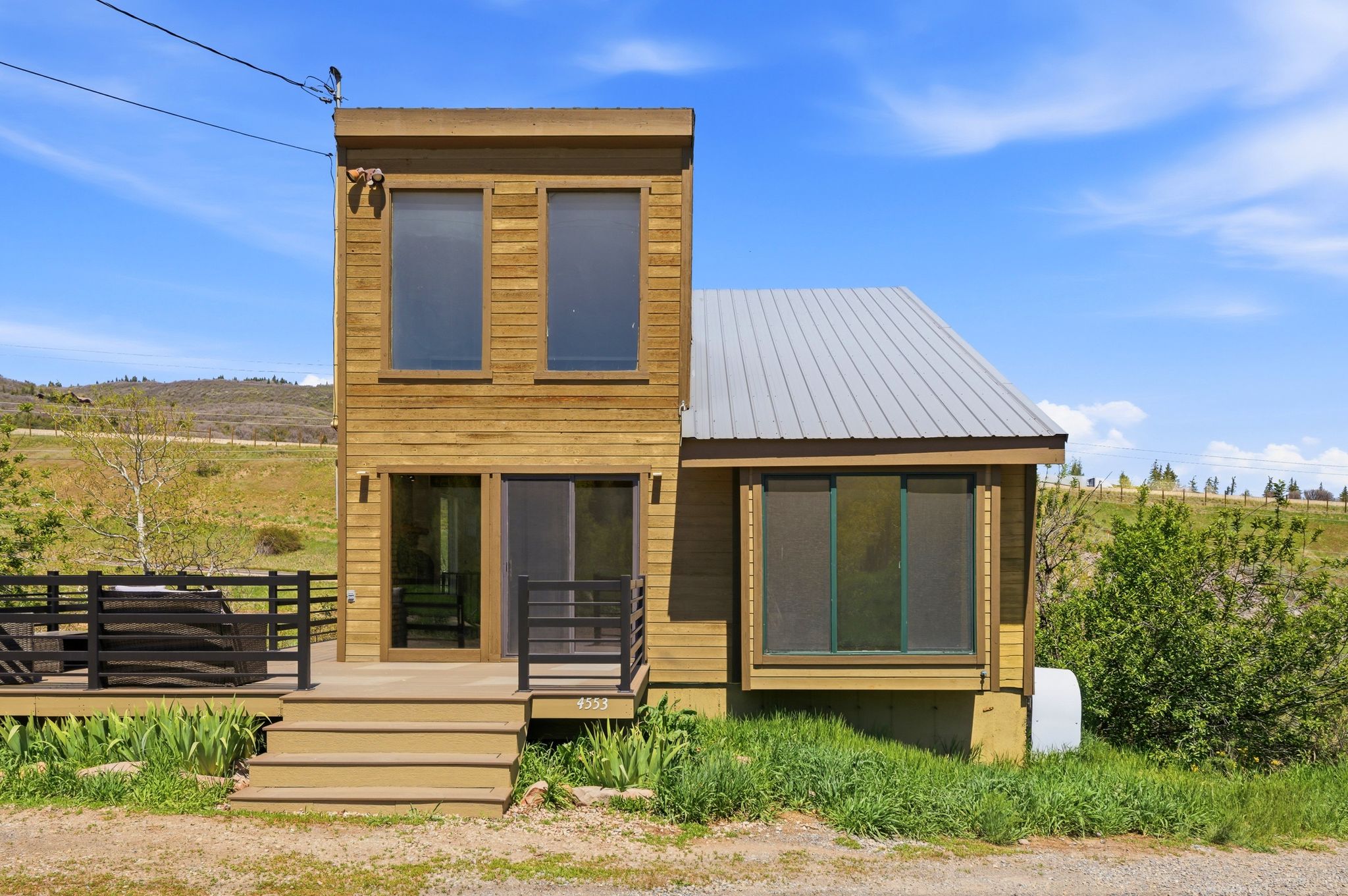 Modern exterior featuring horizontal wood siding and a metal roof