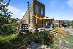 Rear view of property with a deck