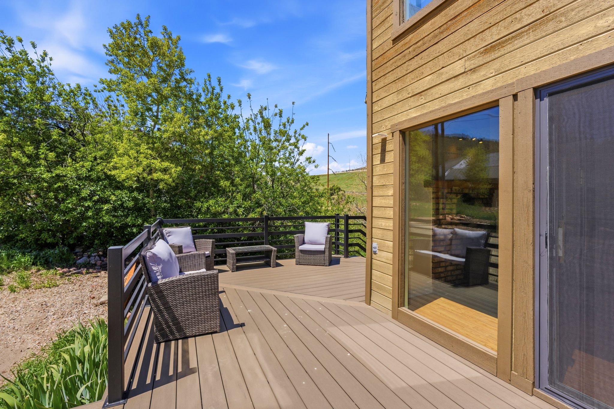 Expansive outdoor deck featuring composite decking and black metal railings
