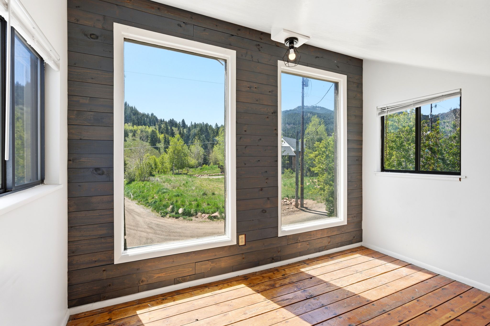Vertical window wall with horizontal wood paneling