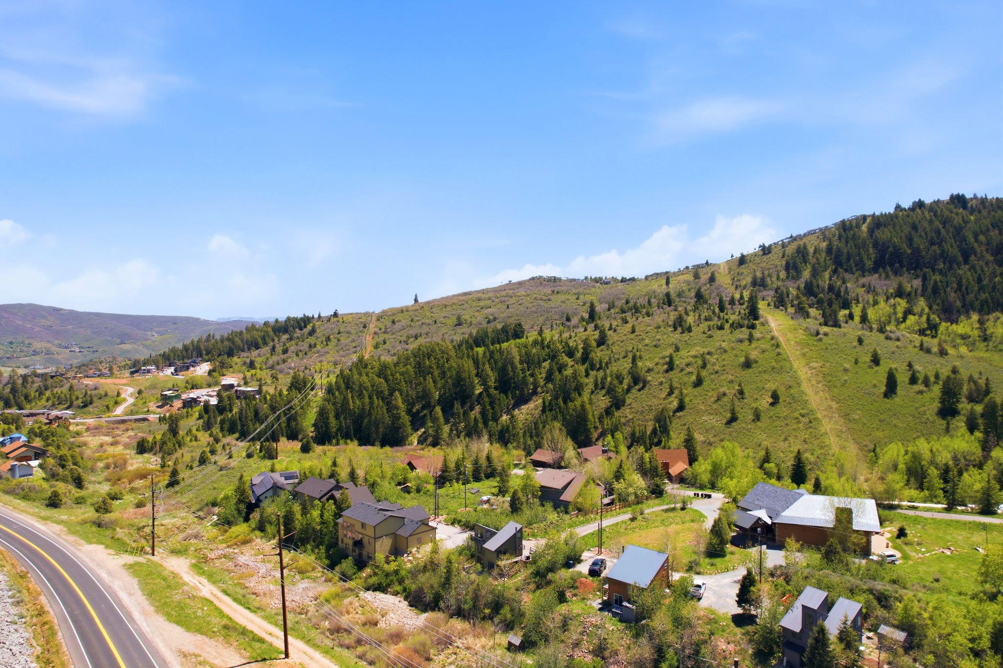 Expansive mountain landscape with diverse terrain and distant hills