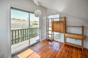 Bonus room with vaulted ceiling and hardwood / wood-style floors