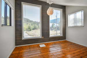 Unfurnished dining area with wood walls