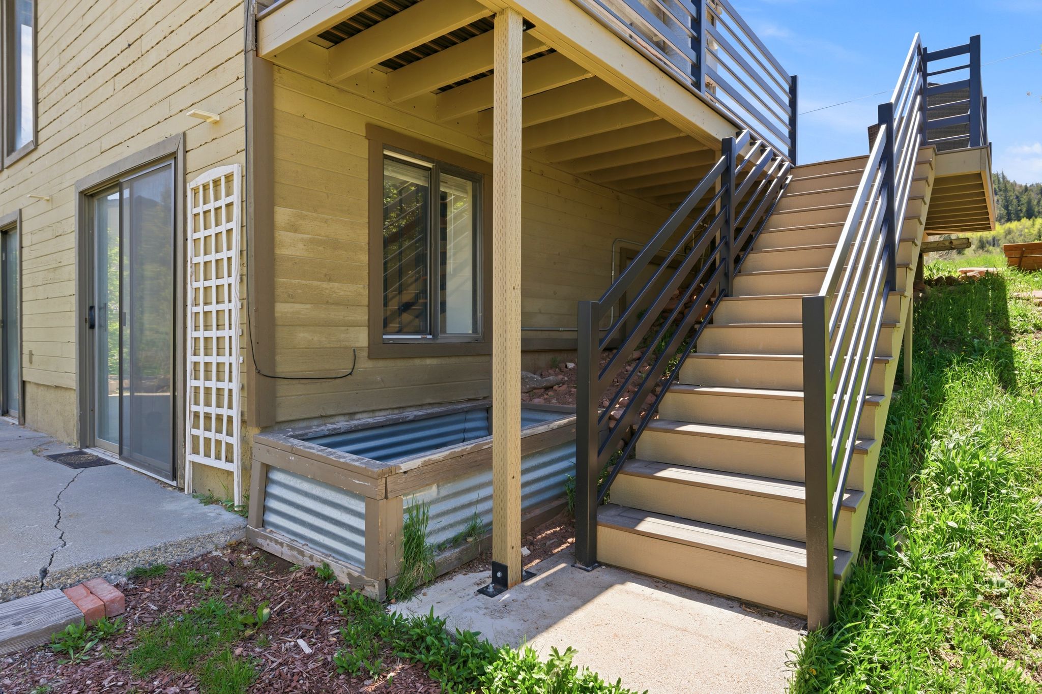 Exterior staircase with contemporary metal railings and composite treads